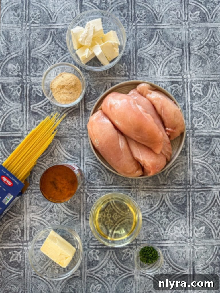 A serving of Slow Cooker Angel Chicken pasta in a white bowl, garnished with fresh herbs.
