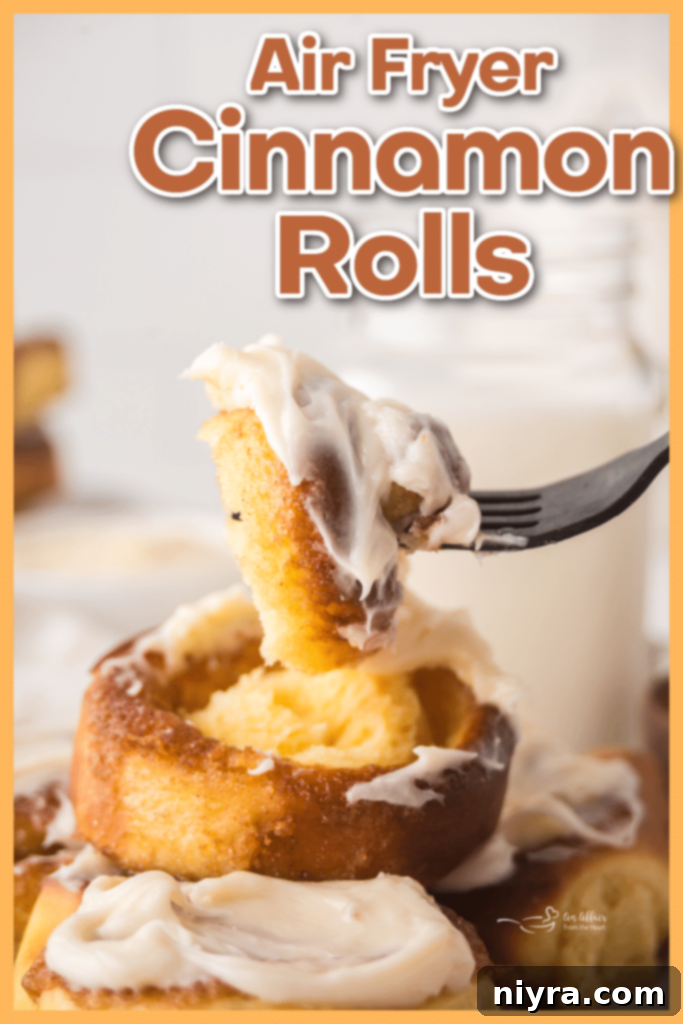 A perfectly golden-brown air fryer cinnamon roll being taken out of the air fryer basket with tongs.