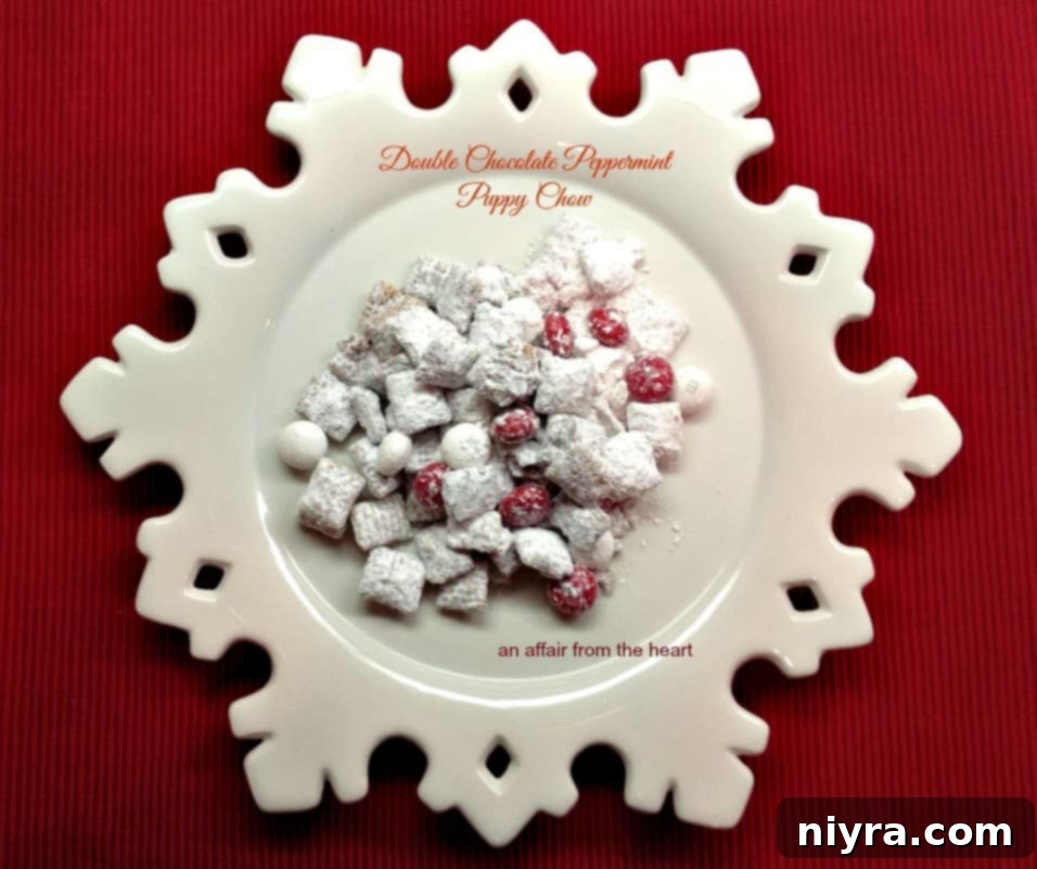 Delicious Double Chocolate Peppermint Puppy Chow on a snowflake plate, ready for the holidays