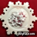 double chocolate peppermint puppy chow on a white snowflake serving platter