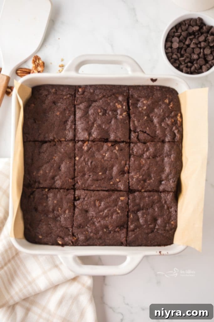 Baked fudgy pecan brownies in a pan, still warm