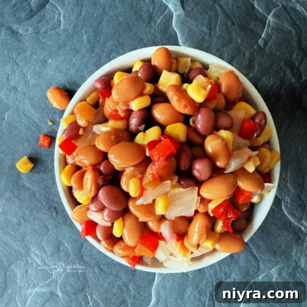 A jar of Paisley Farm Cowboy Caviar, showcasing the colorful mix of beans, corn, and peppers.