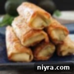 close up of stacked Guacamole Egg Rolls with Spicy Cilantro Ranch Dipping Sauce