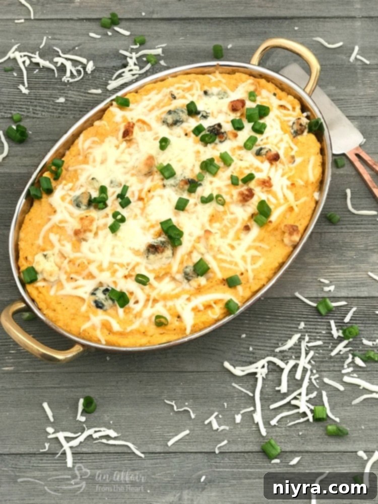 A bowl of Buffalo Cauliflower Dip, perfectly baked and garnished
