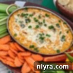 Buffalo Cauliflower Dip surrounded by a variety of vegetables for dipping