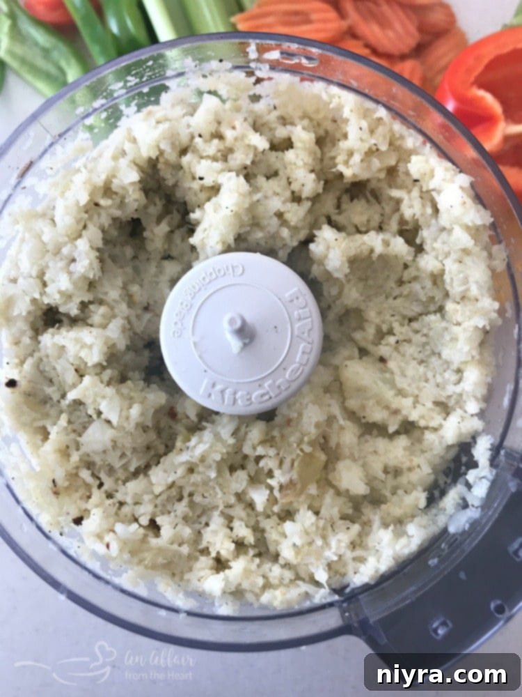 Ingredients for Buffalo Cauliflower Dip being mixed in a bowl