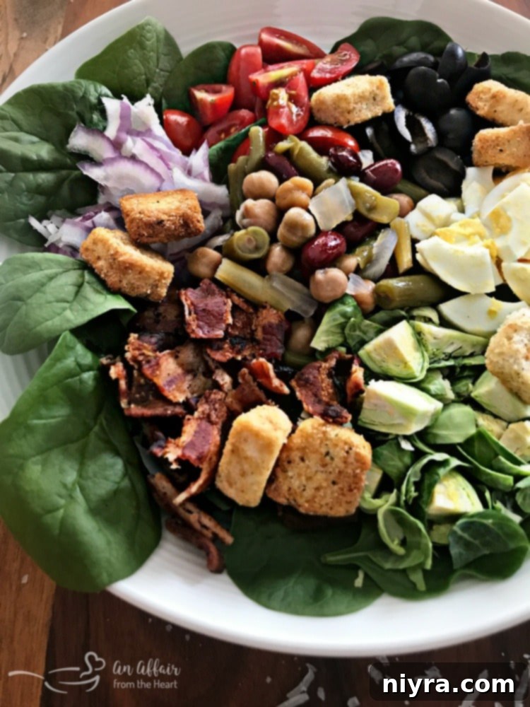 Loaded Spinach Salad with Creamy Roasted Garlic Dressing - a close-up of the delicious textures and colors.