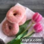 Sweet-Tart Cherry Lime Baked Donuts 14 Overhead of Cherry Limeade Baked Donuts and tulips on a white cloth napkin
