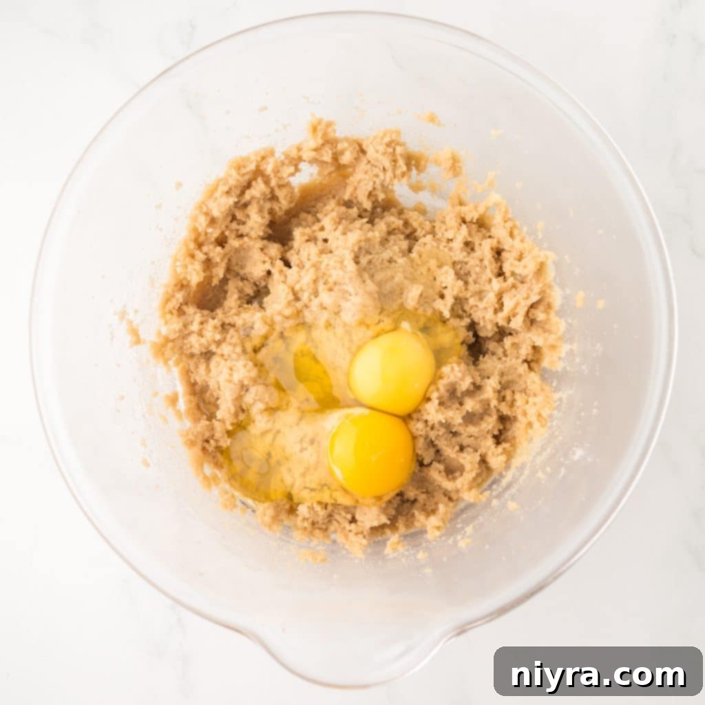 Adding Eggs to the Butter and Sugar Mixture