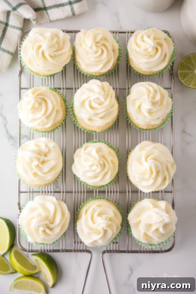 Lime Bliss Cupcakes 9 Piping Cream Cheese Frosting onto Key Lime Cupcakes