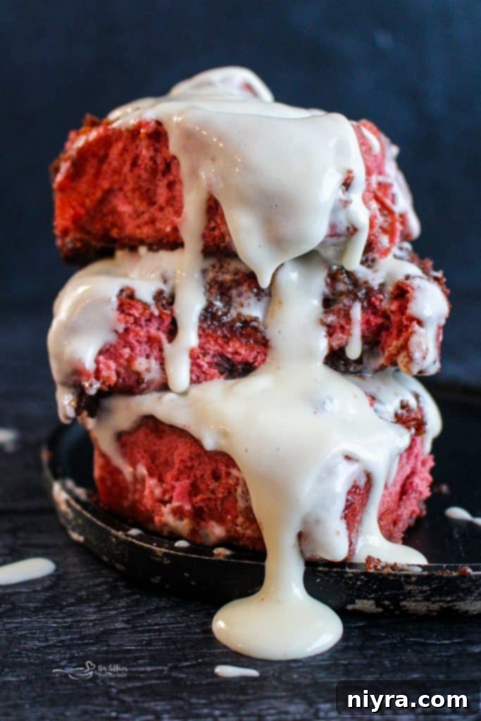 Close-up of a Red Velvet Cinnamon Roll showing the layers of dough and filling