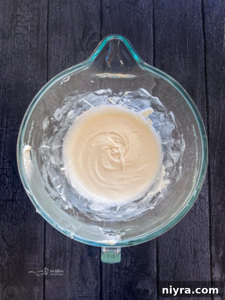 Making the cream cheese frosting for Red Velvet Cinnamon Rolls